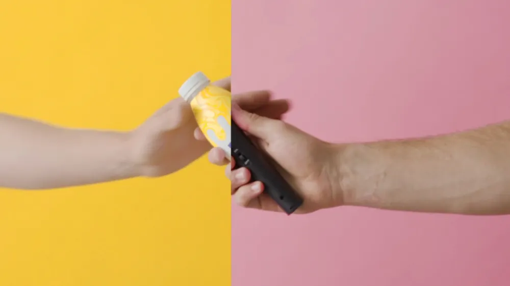 Hand passing a Primo bottle across yellow and pink