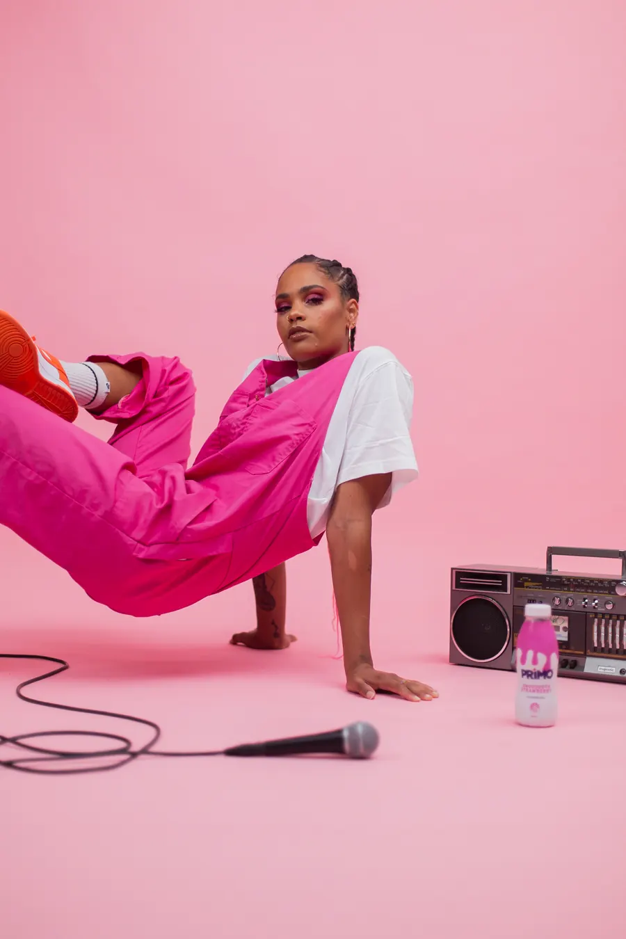Jess B on a pink set with a boombox