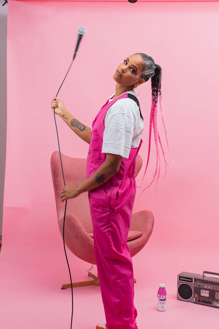 Jess B with microphone on pink